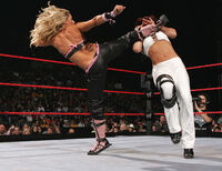 Alexis Rose doing her finisher the Bleeding Rose to Kael Blackstone.