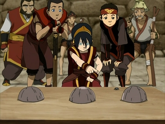 Toph uses earthbending to scam a dealer.